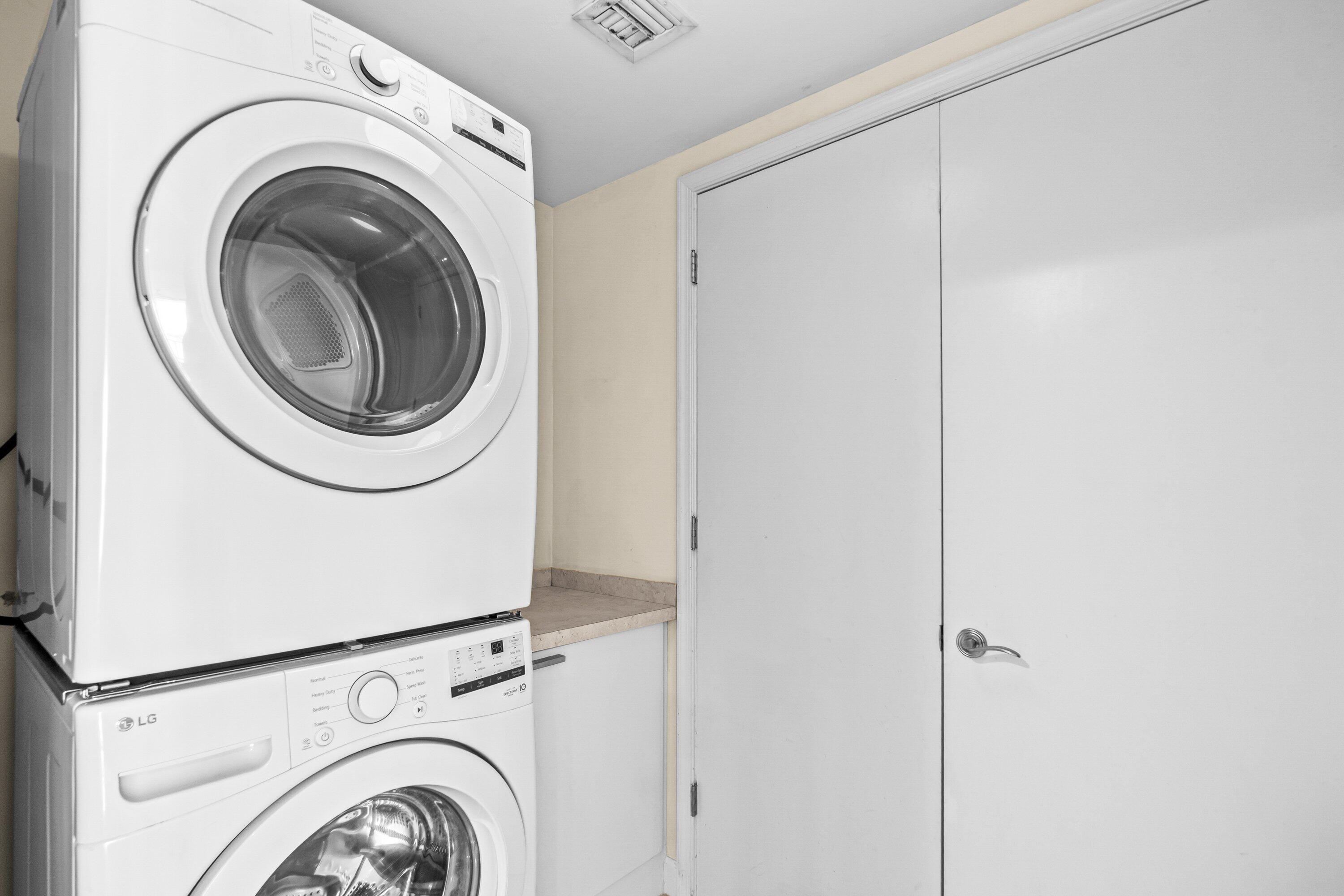 2650 Lake Shore Drive, Unit 703 Riviera Beach, FL 33404 - Photo 27 of 56 a utility room with dryer and washer