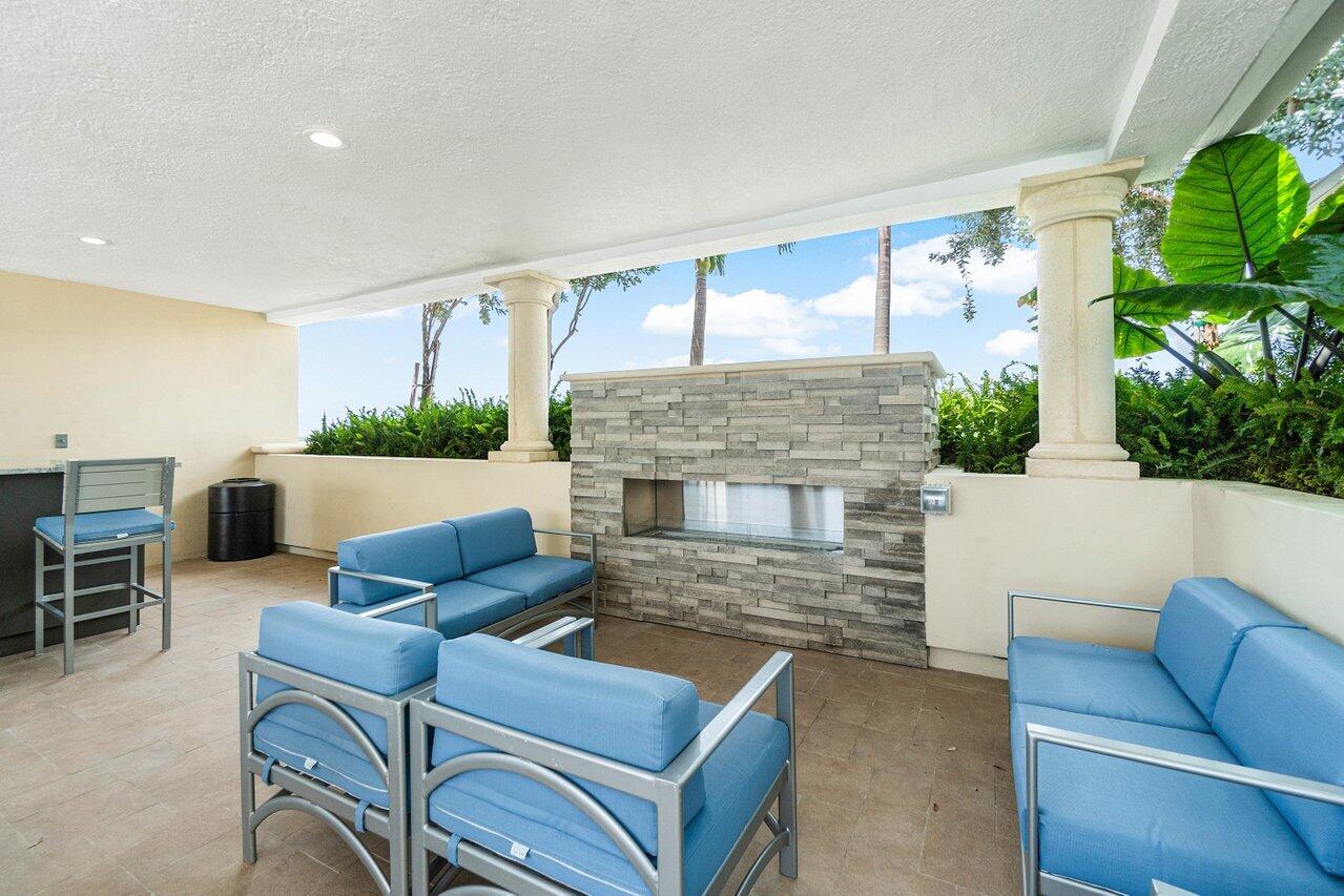 2650 Lake Shore Drive, Unit 703 Riviera Beach, FL 33404 - Photo 49 of 56 a living room with furniture and a fireplace