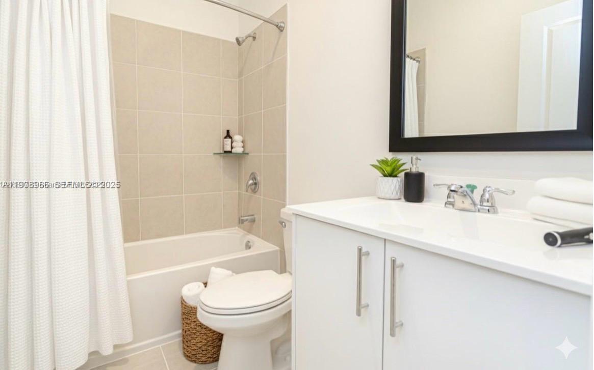 2894 Southeast 26th Terrace, Unit 1 Homestead, FL 33035 - Photo 11 of 11 a bathroom with a sink a toilet and shower