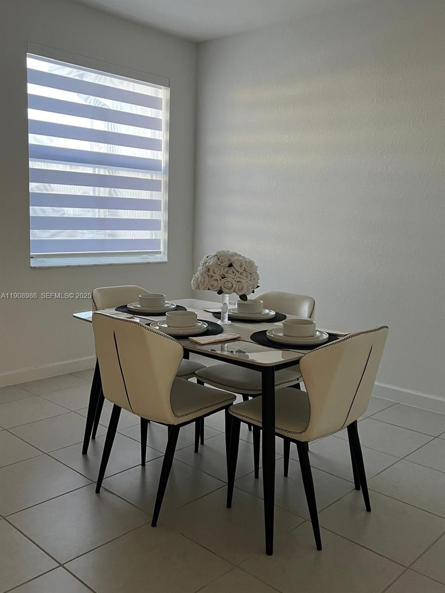 2894 Southeast 26th Terrace, Unit 1 Homestead, FL 33035 - Photo 6 of 11 a view of a dining room with furniture and window