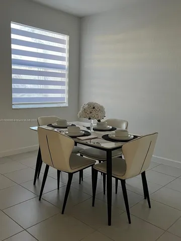 a view of a dining room with furniture and window