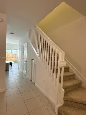 a view of staircase with lots of frames and rug