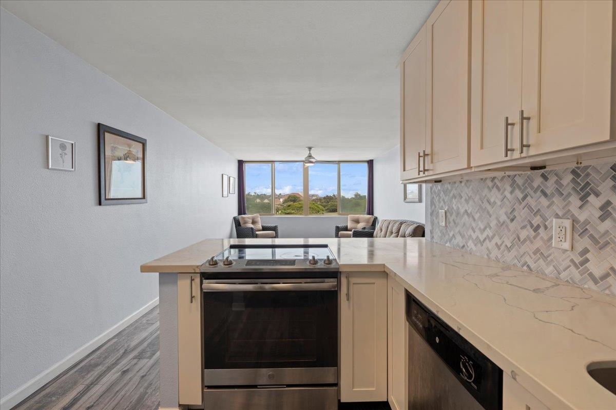 111 Kahului Beach Road, Unit D412 Kahului, HI 96732 - Photo 23 of 37 a kitchen with stainless steel appliances granite countertop a stove a sink and a microwave
