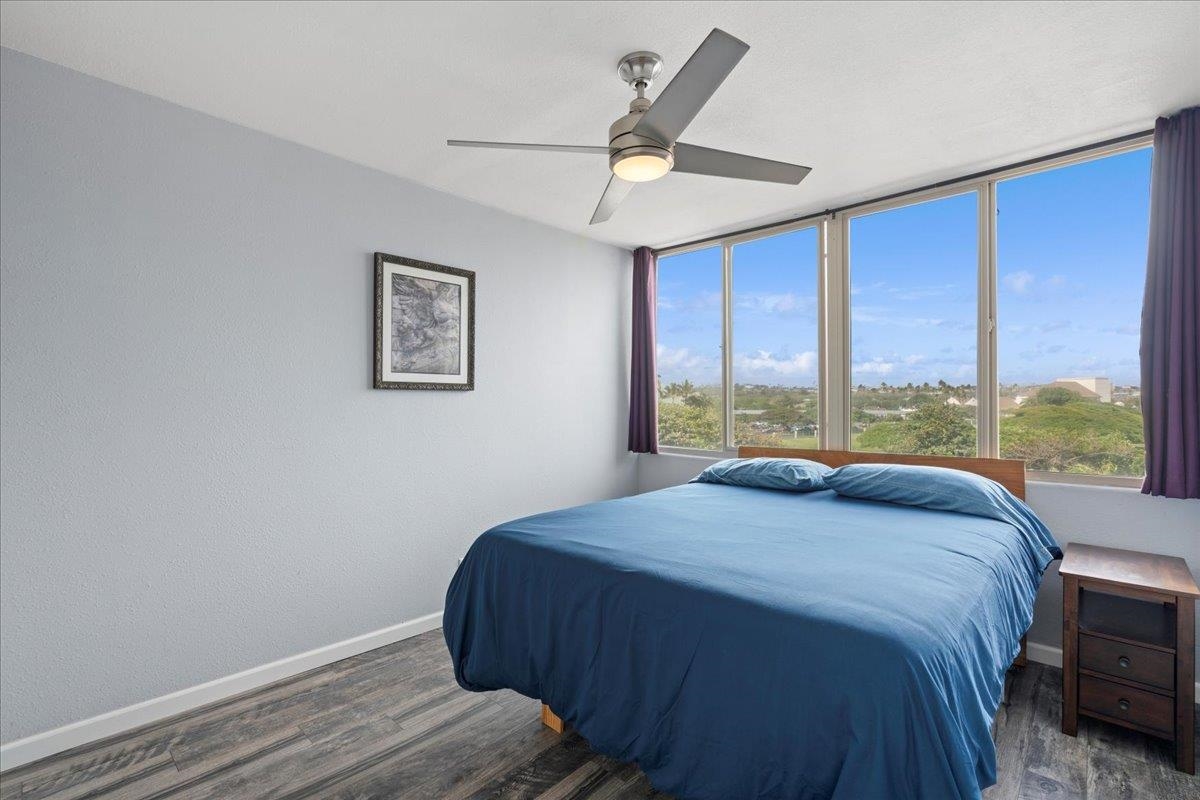 111 Kahului Beach Road, Unit D412 Kahului, HI 96732 - Photo 25 of 37 a bedroom with a large bed and a large window