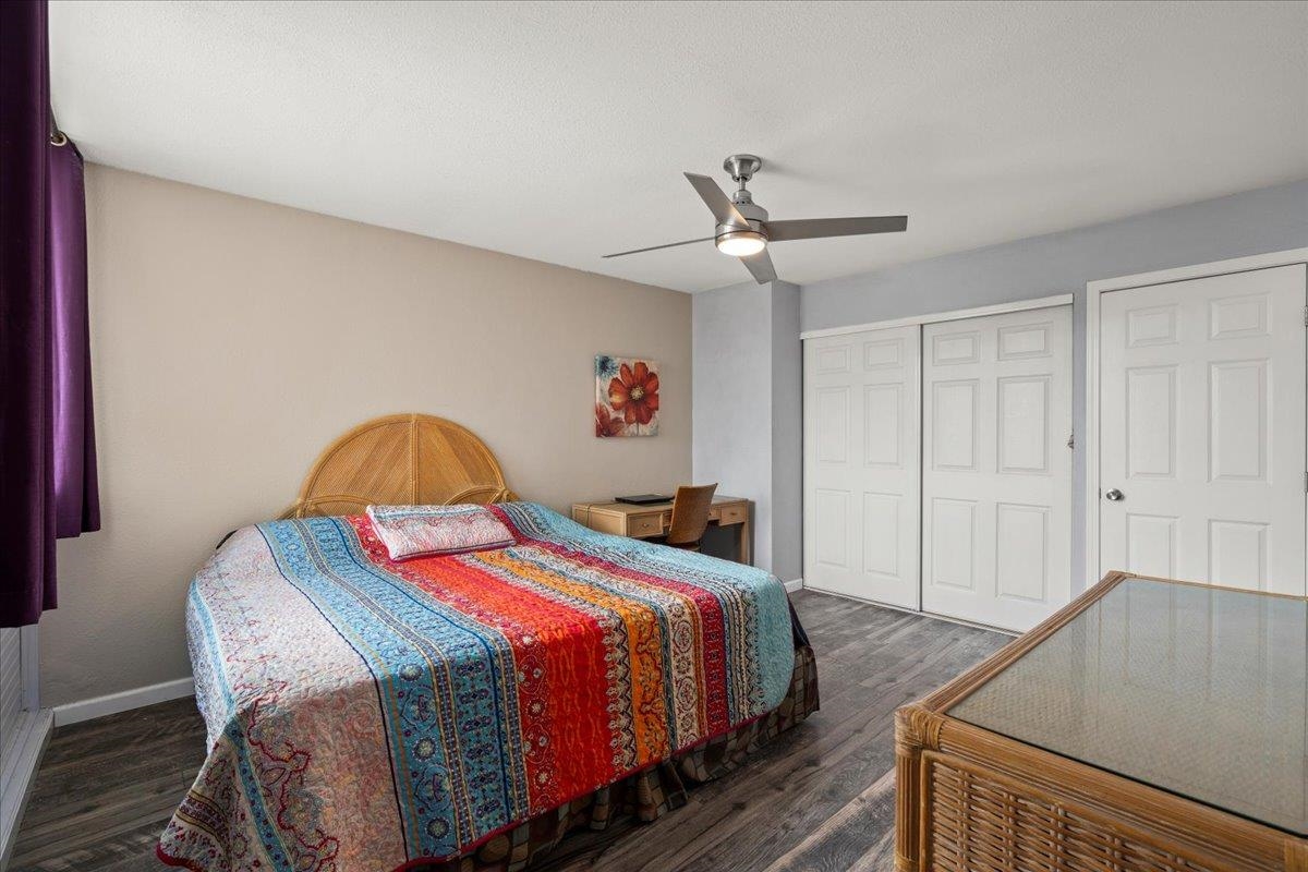 111 Kahului Beach Road, Unit D412 Kahului, HI 96732 - Photo 31 of 37 a bedroom with a bed and a chandelier