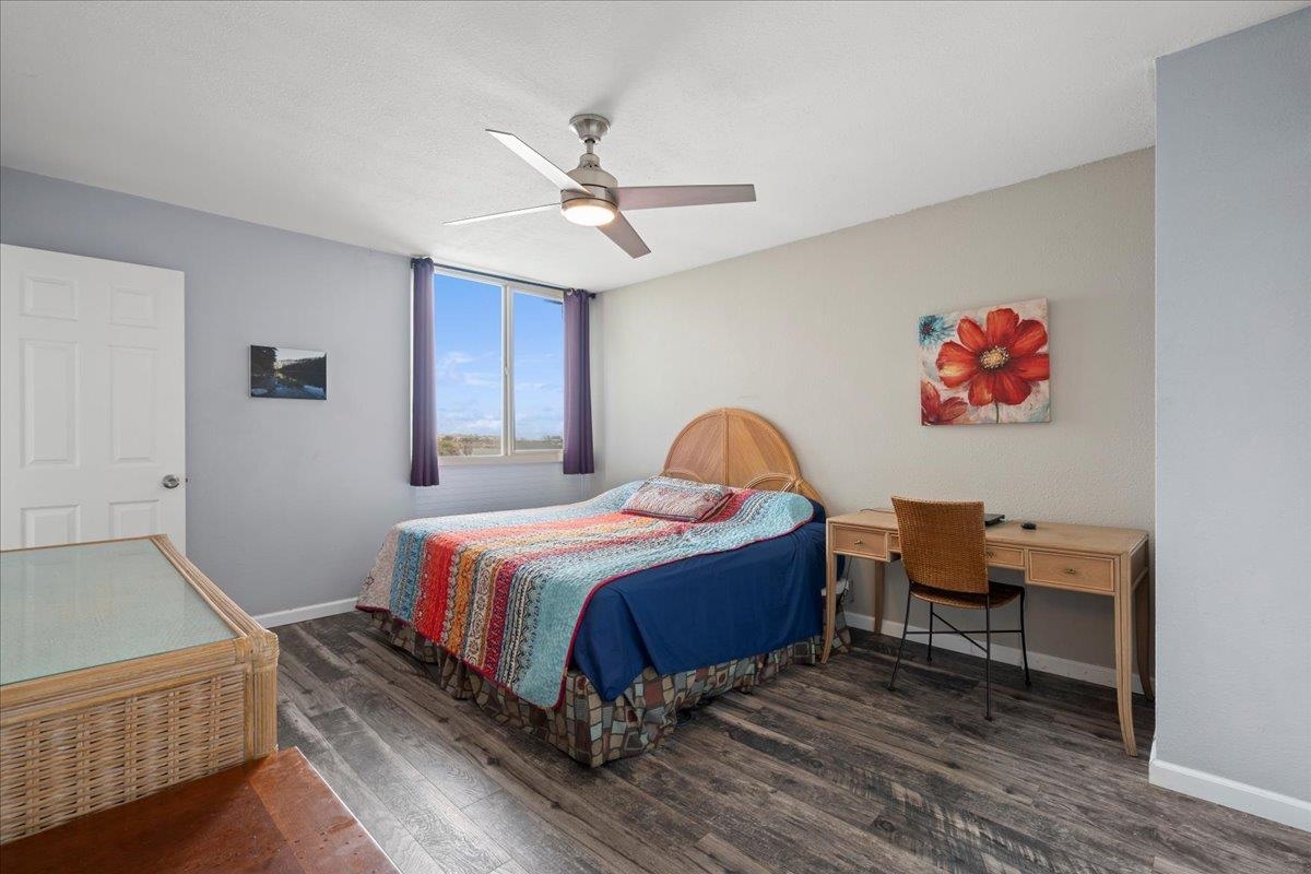 111 Kahului Beach Road, Unit D412 Kahului, HI 96732 - Photo 32 of 37 a spacious bedroom with a bed and a chandelier