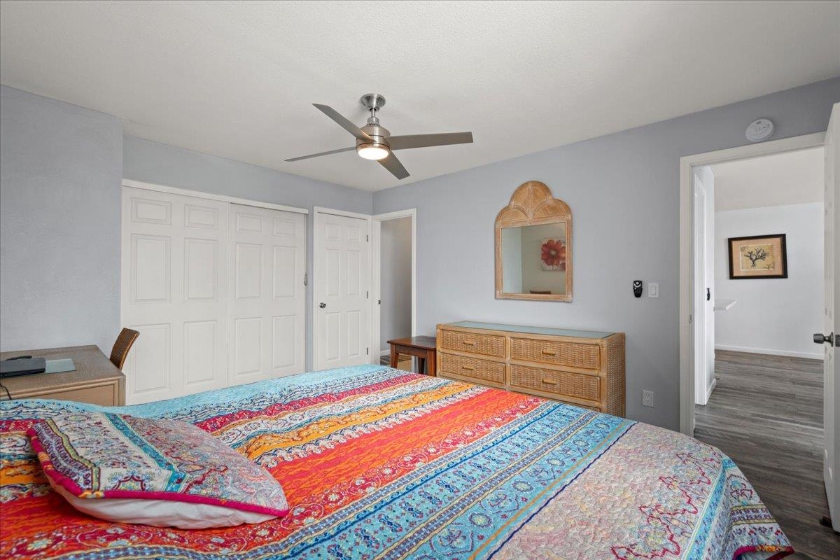 111 Kahului Beach Road, Unit D412 Kahului, HI 96732 - Photo 5 of 37 a bedroom with a bed and a chandelier