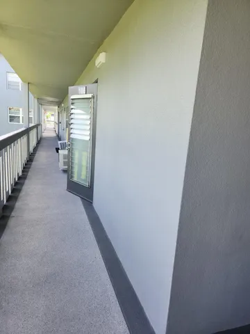 a view of a hallway with windows