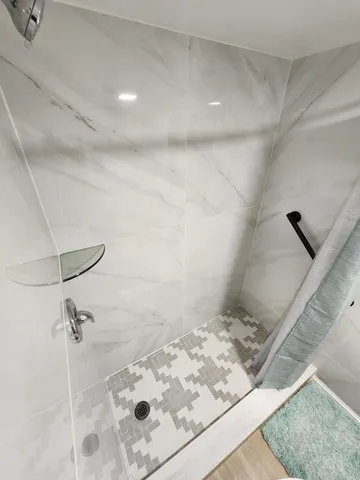 a bathroom with a bathtub and shower