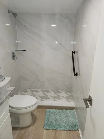 a bathroom with a toilet and a shower