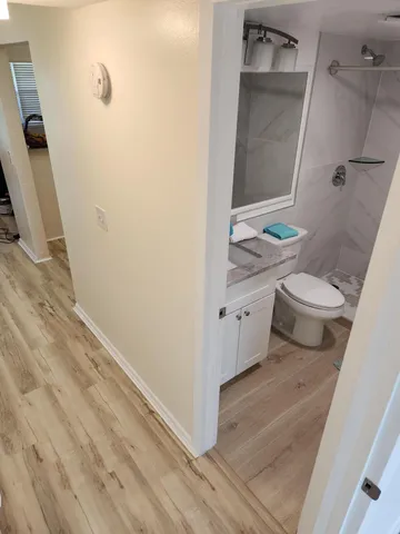 a view of a room with wooden floor