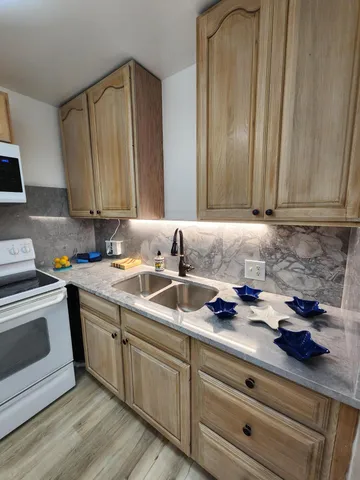 a kitchen with a refrigerator and a sink
