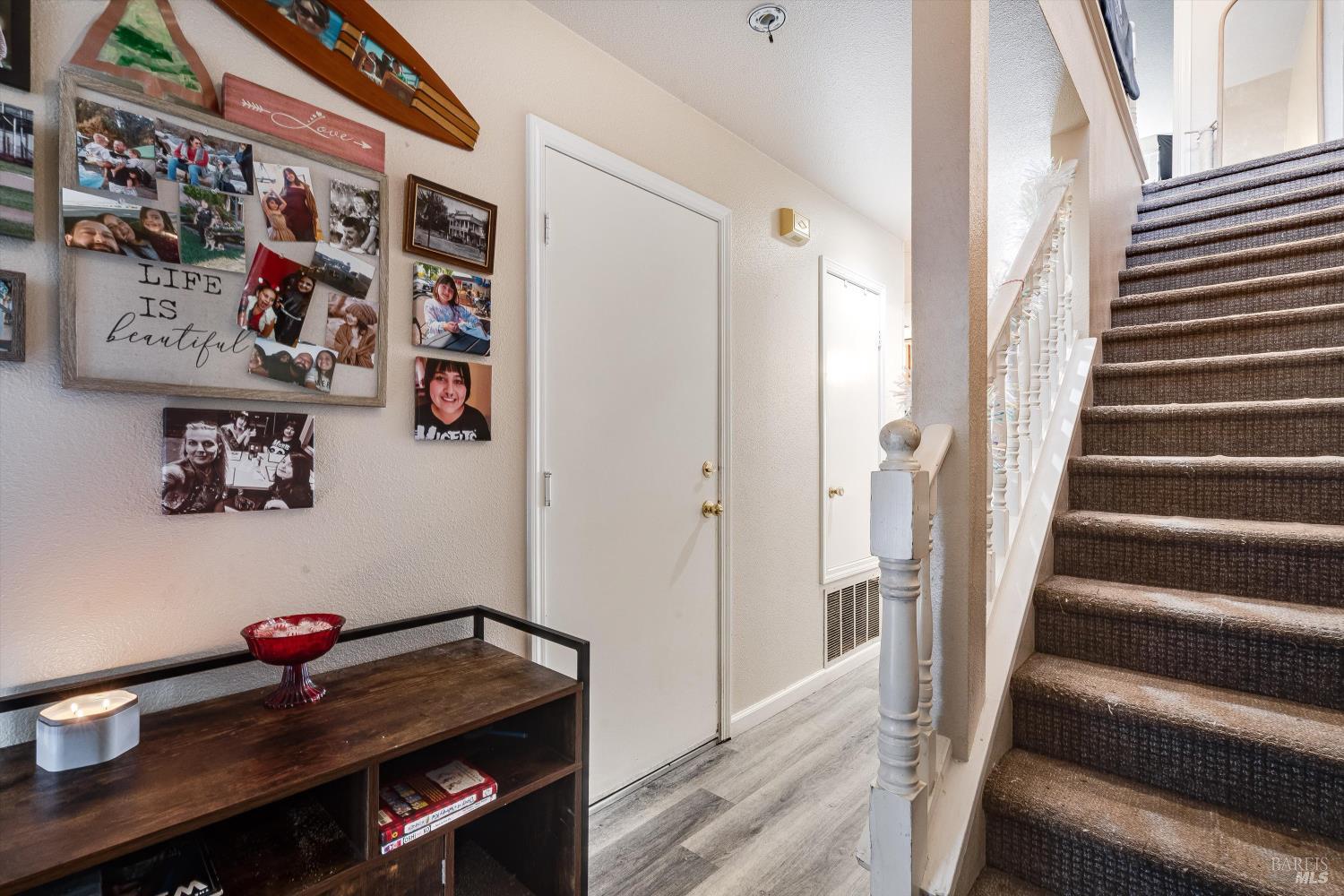 590 Laurel Grove Circle Santa Rosa, CA 95407 - Photo 21 of 44 a view of an entryway with lots of frames on wall and a potted plant