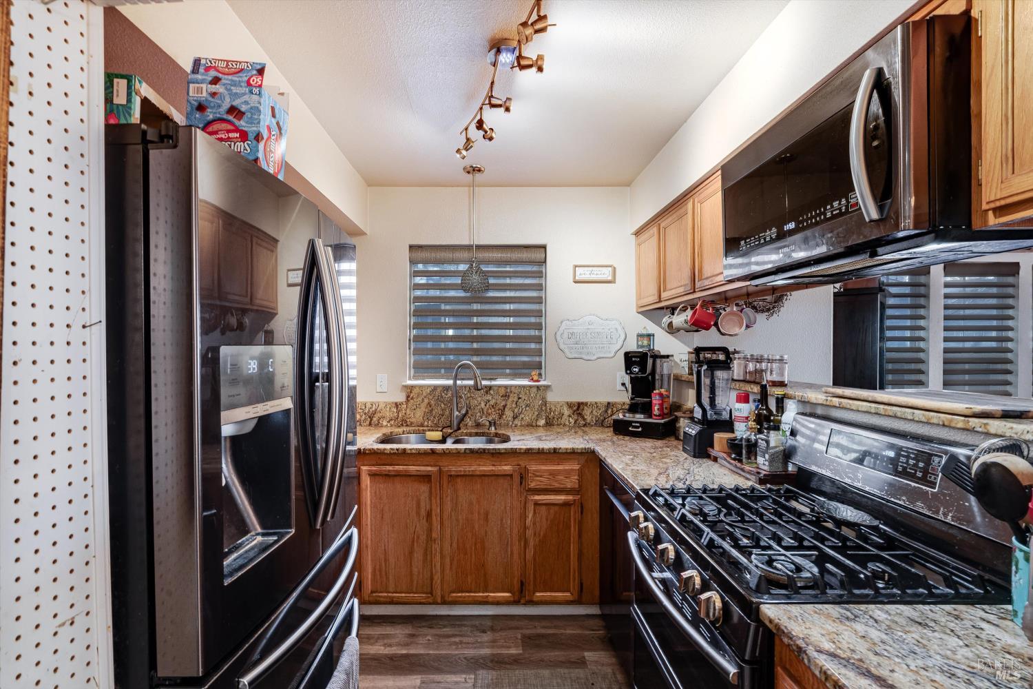 590 Laurel Grove Circle Santa Rosa, CA 95407 - Photo 34 of 44 a kitchen with stainless steel appliances granite countertop a stove and a refrigerator