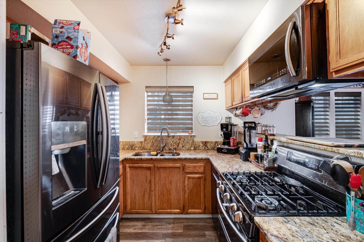 590 Laurel Grove Circle Santa Rosa, CA 95407 - Photo 36 of 44 a kitchen with stainless steel appliances granite countertop a stove and a refrigerator