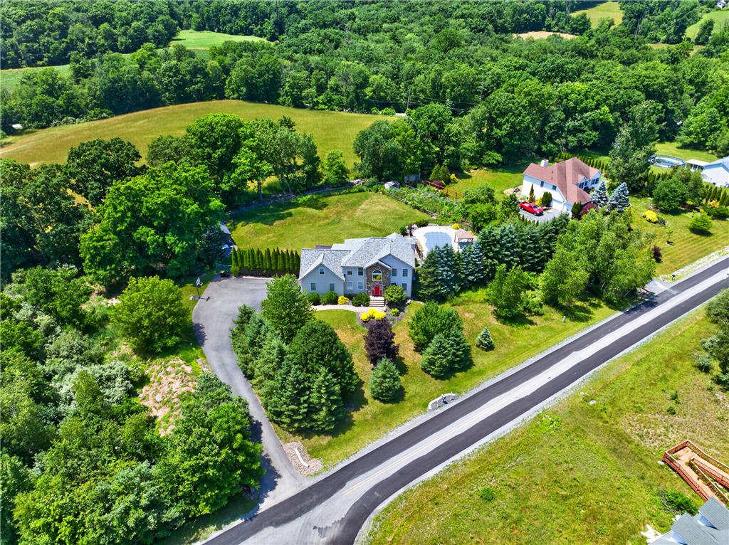220 Pennbrook Road Stroudsburg, PA 18360 - Photo 7 of 60 An aerial panorama showcases a graceful home nestled among verdant trees and sprawling grounds.