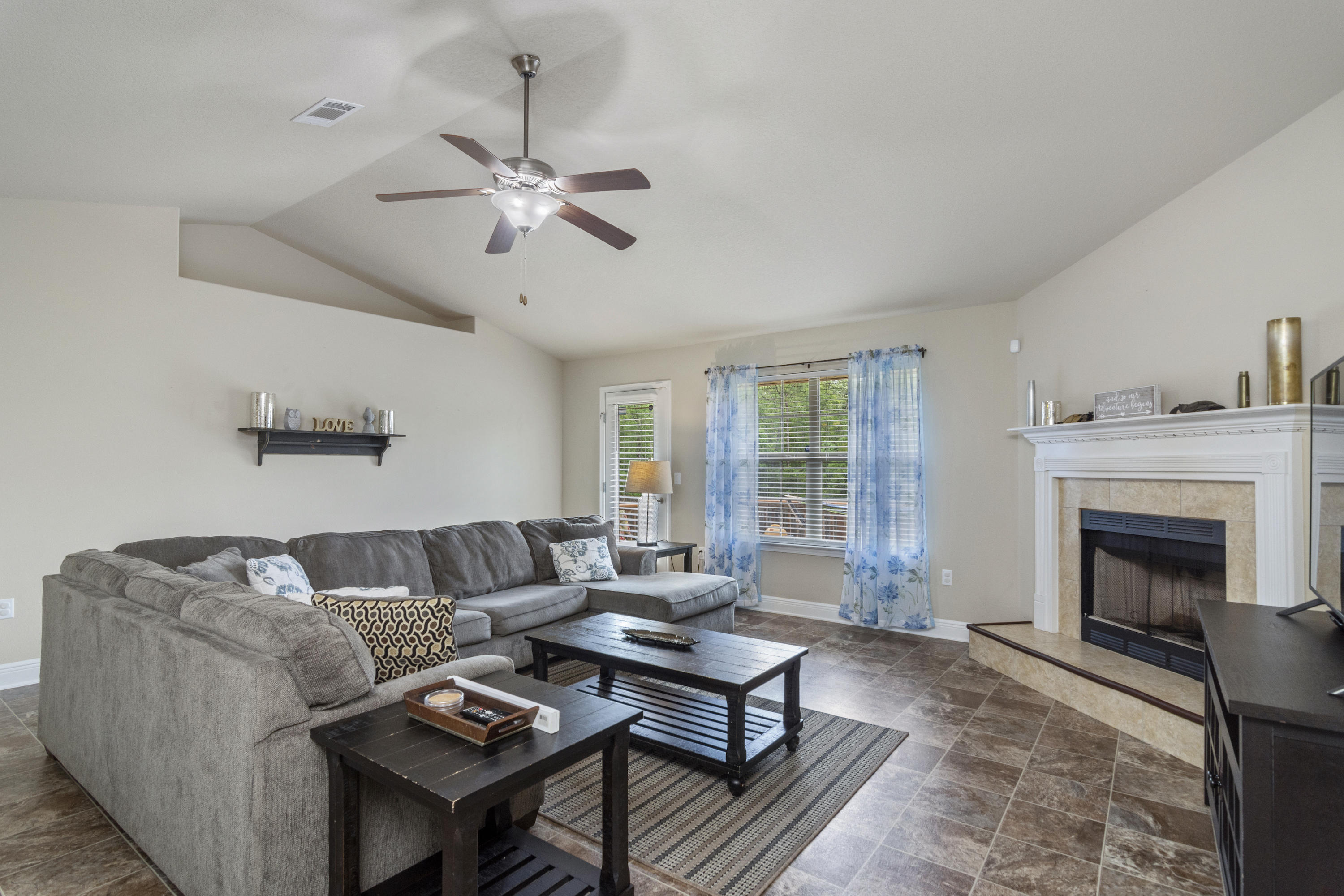 306 Gauntlet Drive Crestview, FL 32539 - Photo 11 of 32 a living room with furniture a fireplace and a chandelier