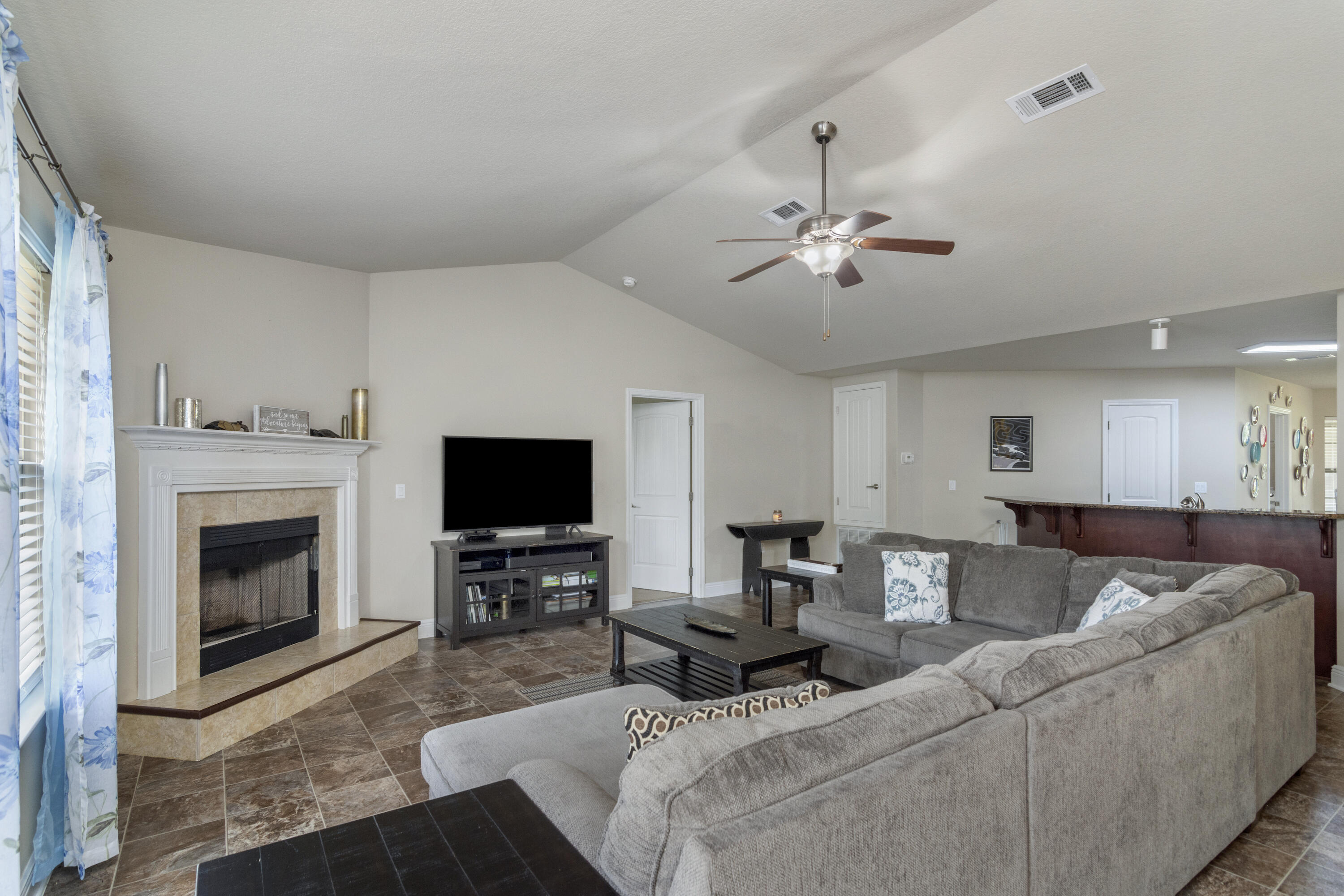 306 Gauntlet Drive Crestview, FL 32539 - Photo 13 of 32 a living room with furniture a fireplace and a flat screen tv