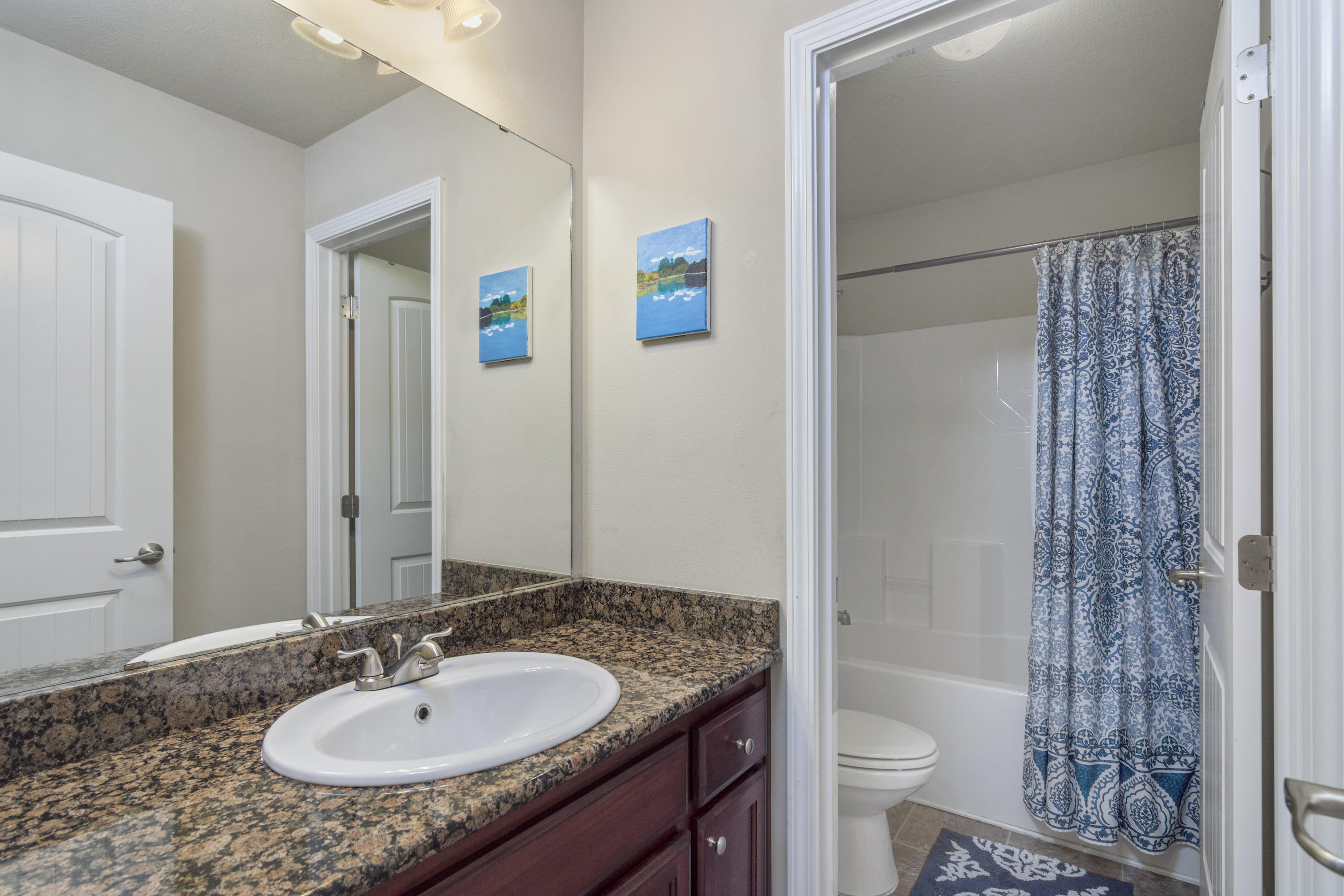306 Gauntlet Drive Crestview, FL 32539 - Photo 23 of 32 a bathroom with a granite countertop sink and a mirror