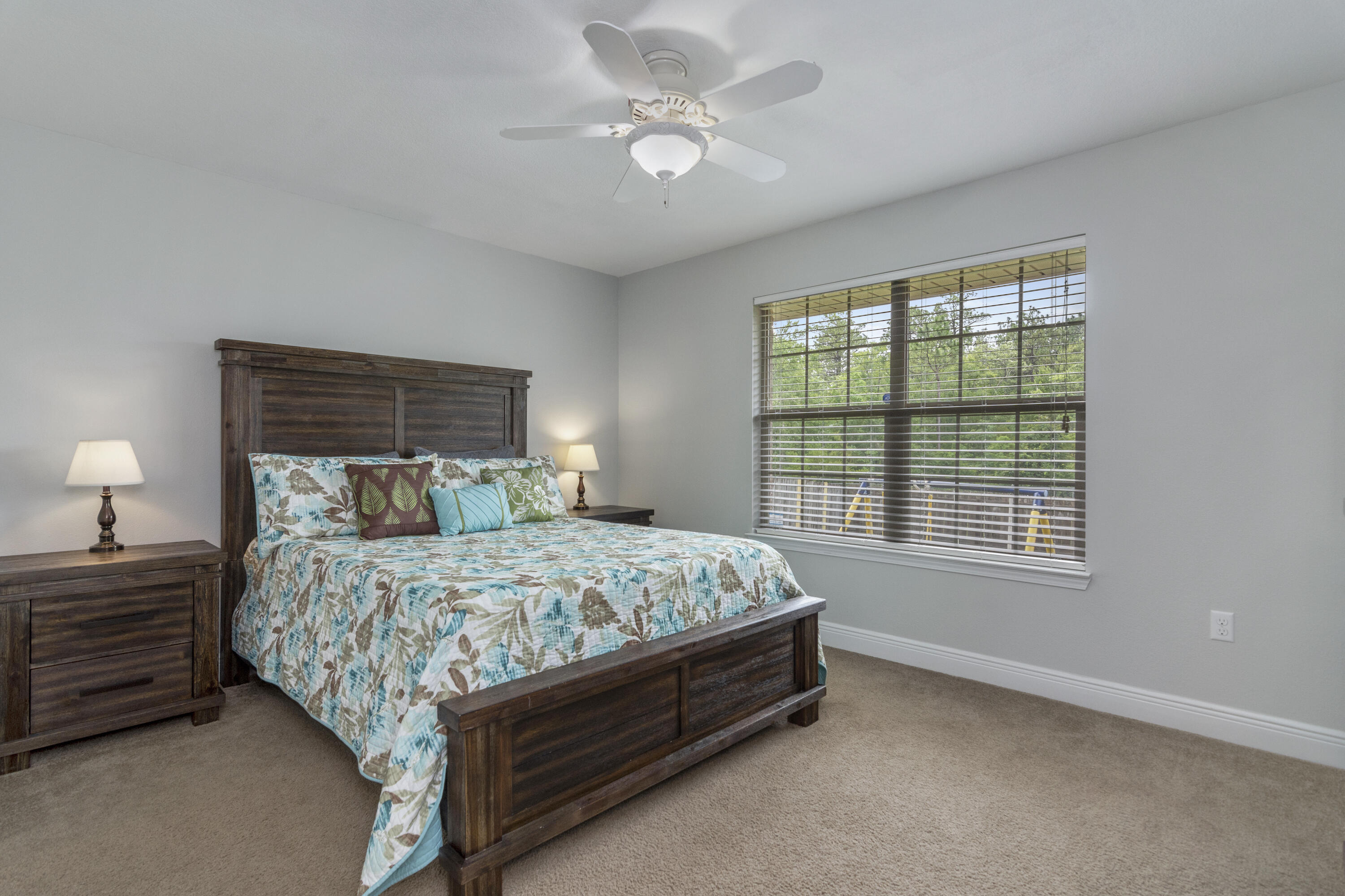 306 Gauntlet Drive Crestview, FL 32539 - Photo 25 of 32 a bedroom with a bed chandelier and a window