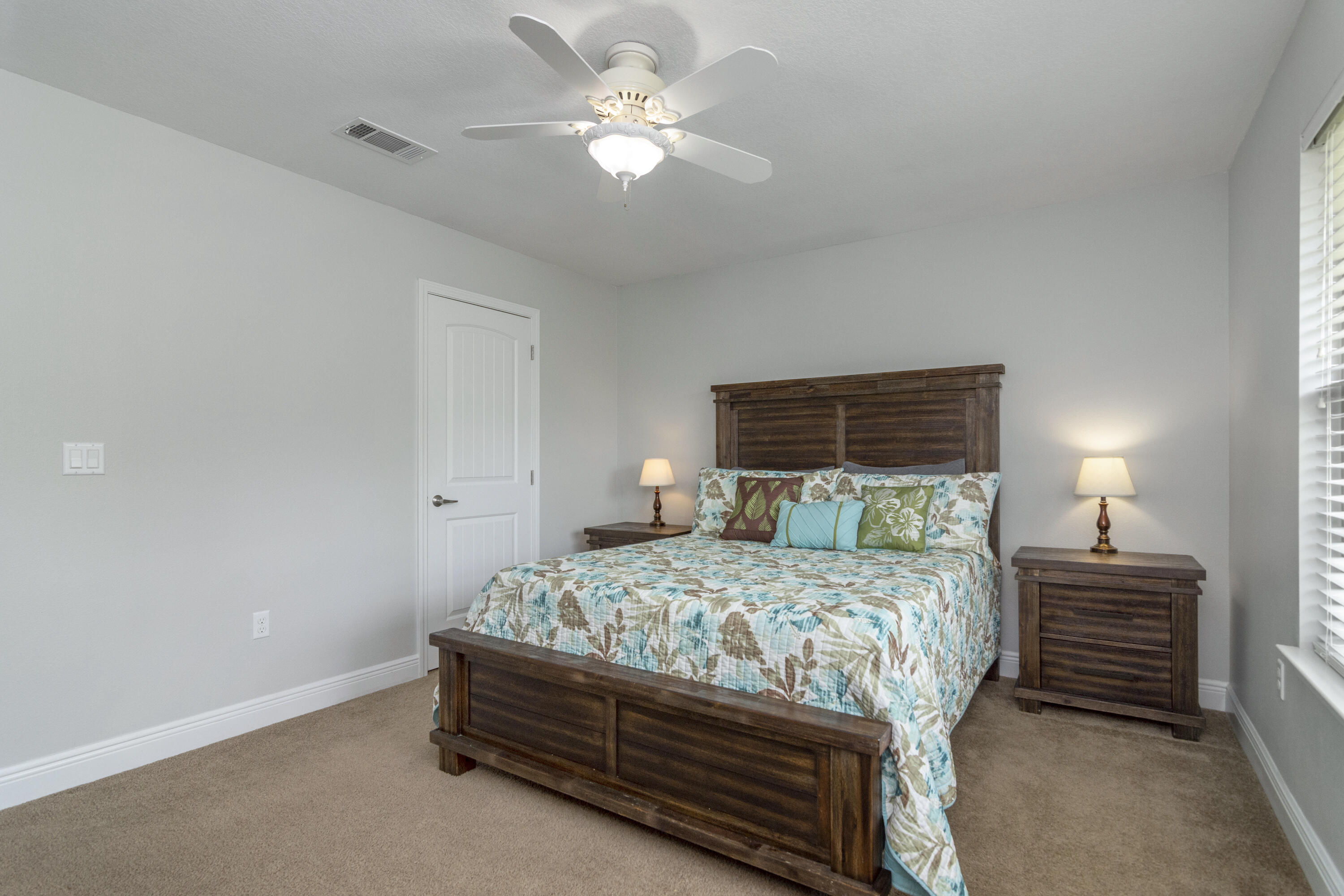 306 Gauntlet Drive Crestview, FL 32539 - Photo 26 of 32 a bedroom with a bed and a ceiling fan