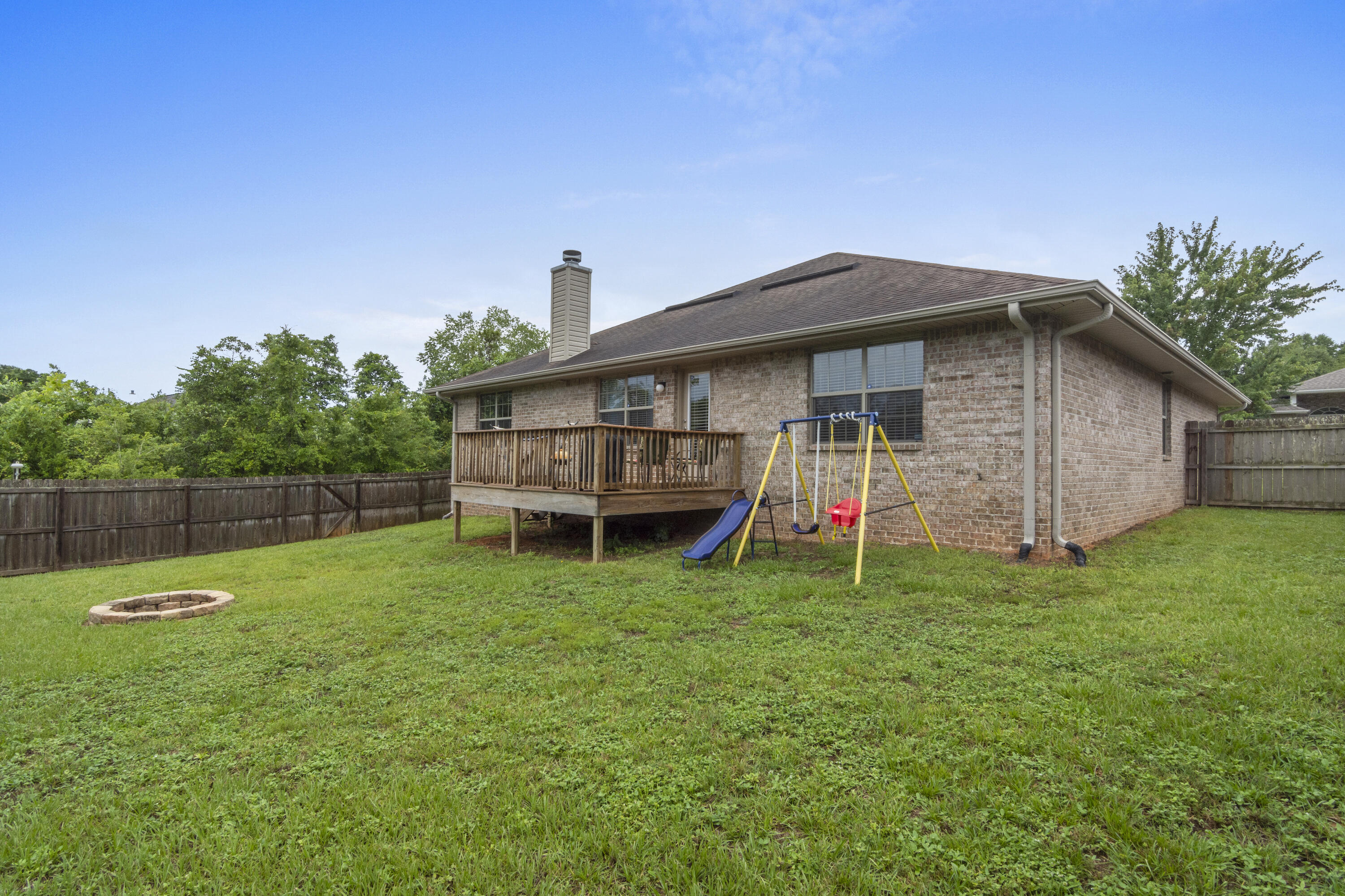 306 Gauntlet Drive Crestview, FL 32539 - Photo 31 of 32 a backyard of a house with table and chairs