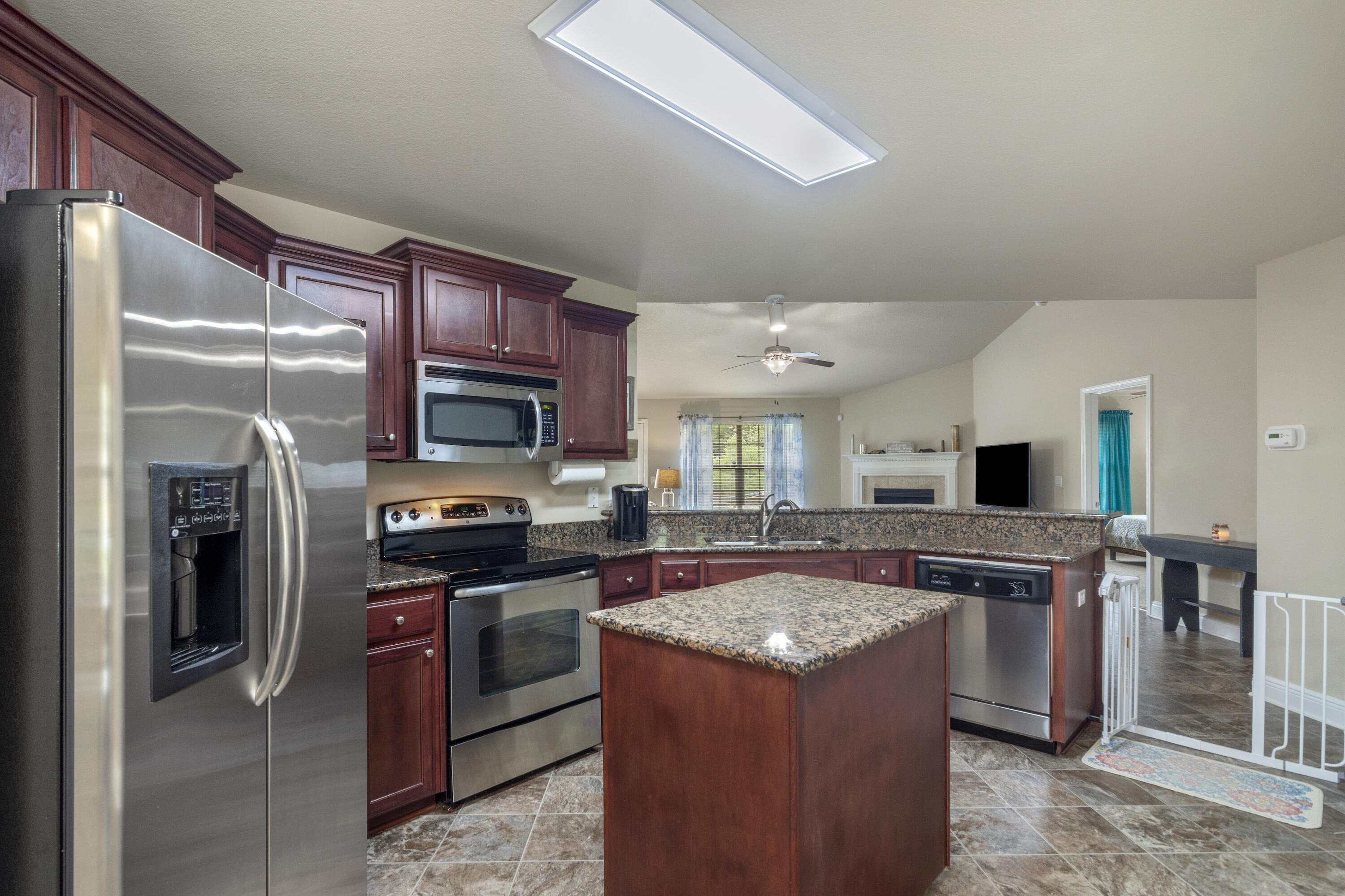 306 Gauntlet Drive Crestview, FL 32539 - Photo 7 of 32 a kitchen with stainless steel appliances granite countertop a stove refrigerator and a sink