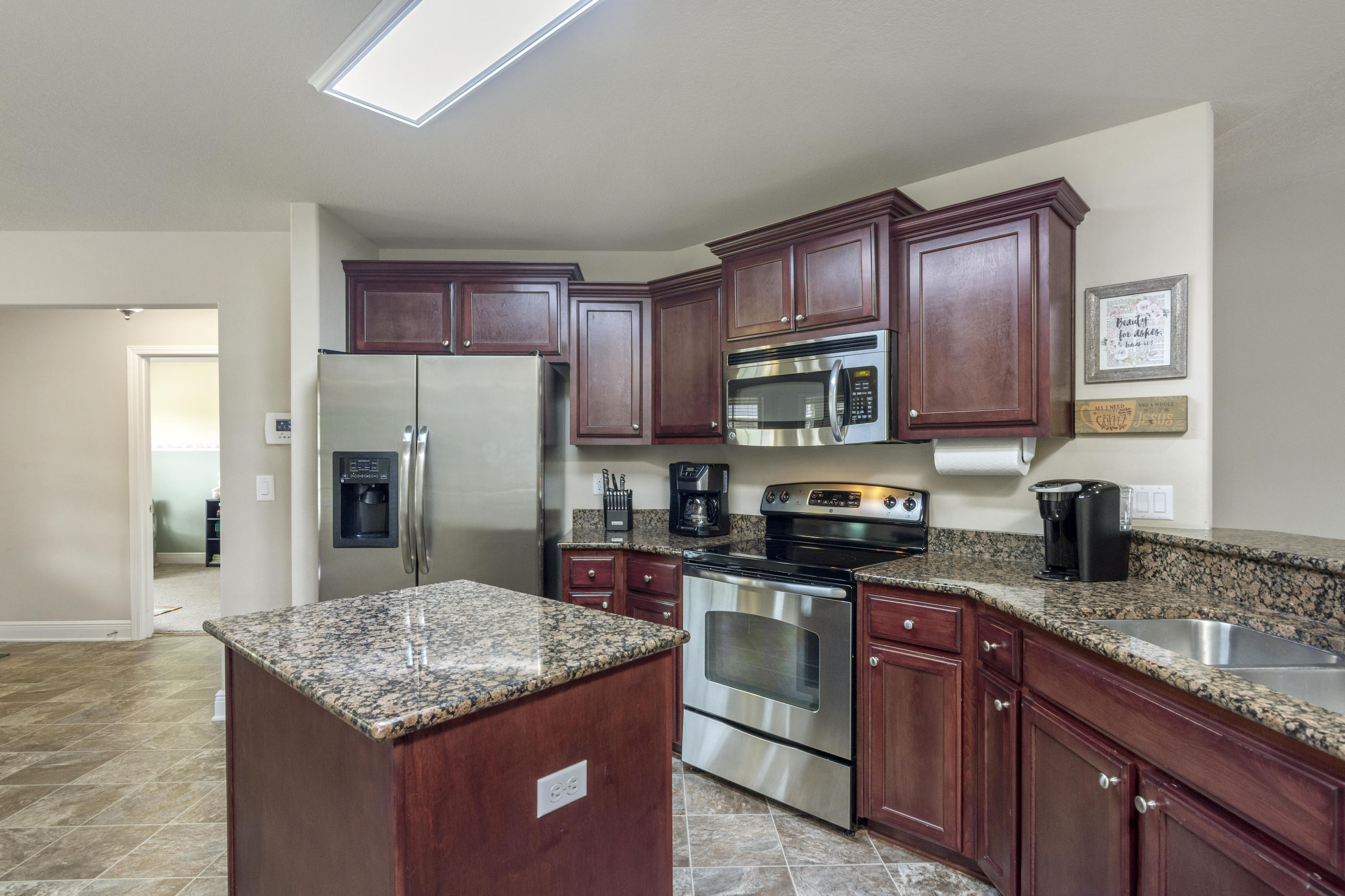 306 Gauntlet Drive Crestview, FL 32539 - Photo 8 of 32 a kitchen with stainless steel appliances granite countertop a stove refrigerator sink and microwave