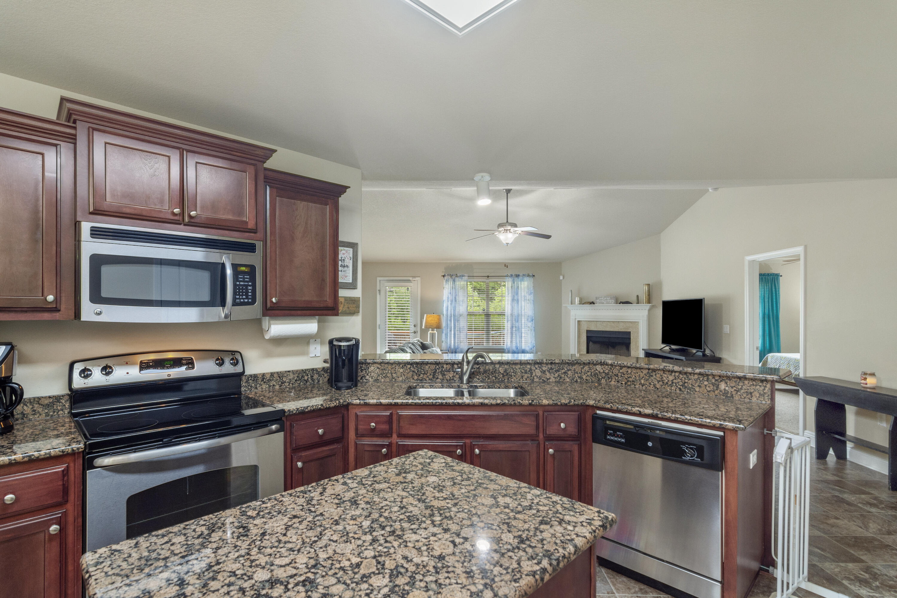 306 Gauntlet Drive Crestview, FL 32539 - Photo 9 of 32 a kitchen with stainless steel appliances granite countertop a stove sink microwave and refrigerator