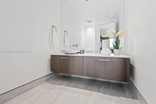 a bathroom with a shower a toilet and sink