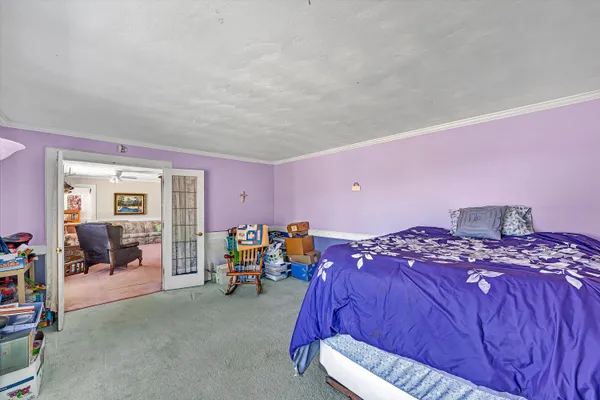 a bedroom with a bed and a chandelier