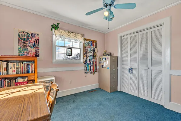 a bedroom with a bed a dresser and book shelf