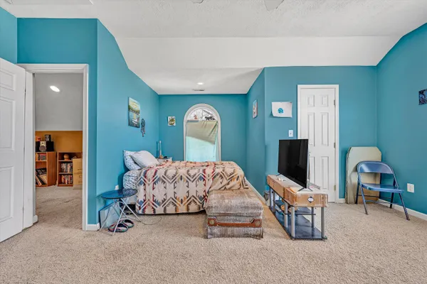 a living room with furniture a rug and white walls