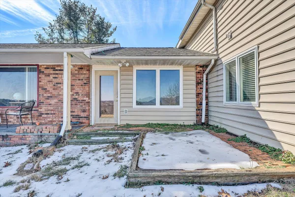 a kitchen with granite countertop a refrigerator a sink a stove and cabinets