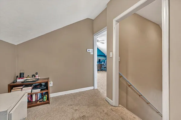 a view of a house with backyard and trees