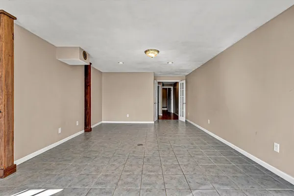 a view of a house with a yard covered in snow