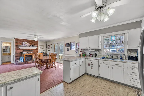 a view of a dining room with furniture and a floor to ceiling window