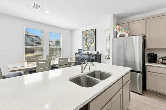 a view of kitchen island a sink and living room