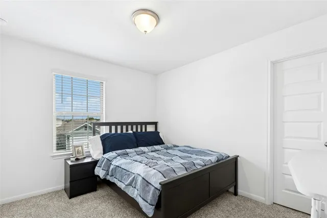 a bedroom with furniture a baby crib and a window