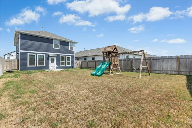 a view of a house with a yard and sitting space