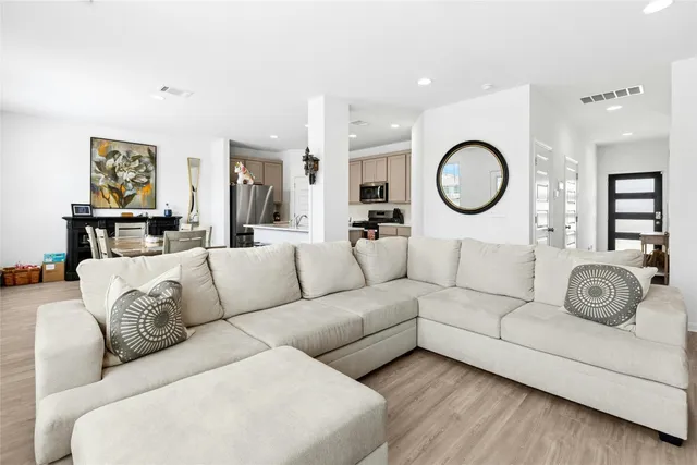 a living room with furniture a clock and wall