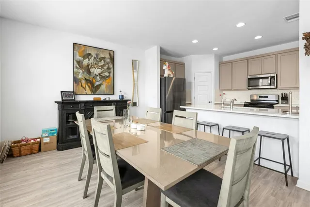 a dining room with furniture and wooden floor