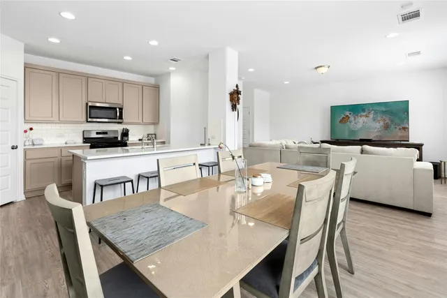 a dining room with kitchen island a table and chairs