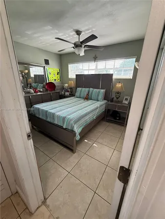 a spacious bedroom with a bed and a mirror