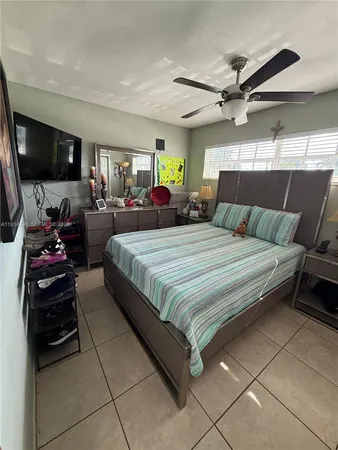 a bedroom with a bed a window and gym equipment