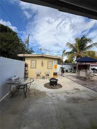 a view of a patio with table and chairs and potted plants