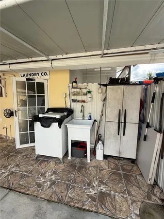 a kitchen with a refrigerator and a counter top space