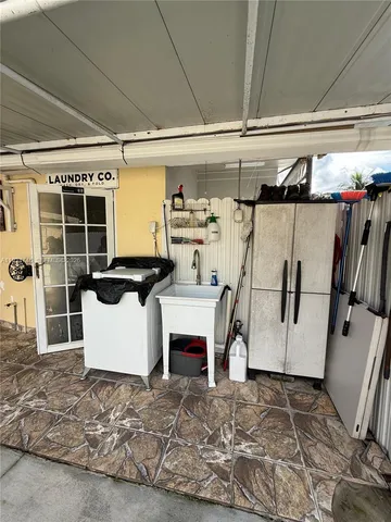 a kitchen with a refrigerator and a counter top space