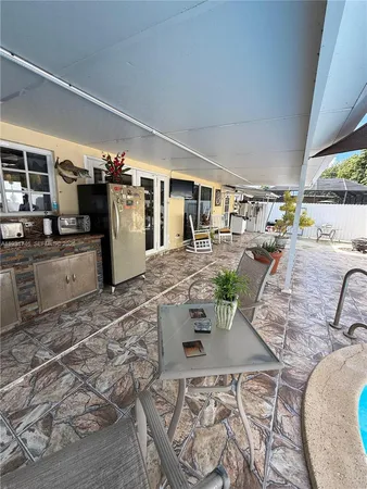 a living room with furniture and a kitchen