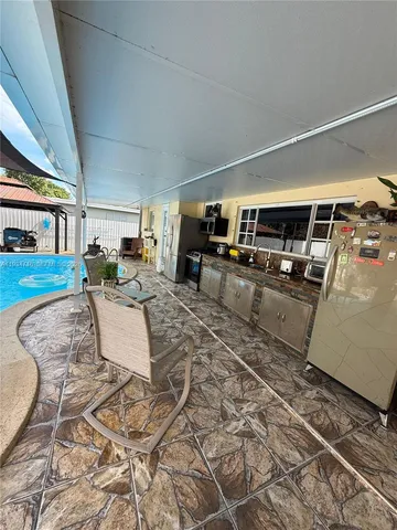 a living room with furniture and kitchen view